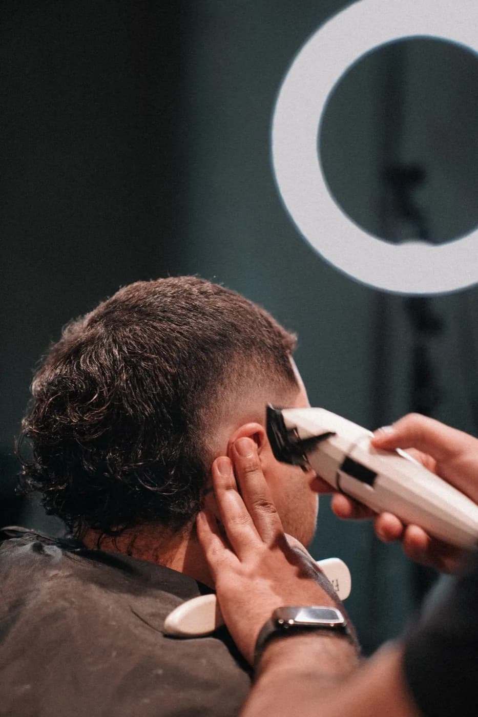 Barber redrawing the beard line with clippers